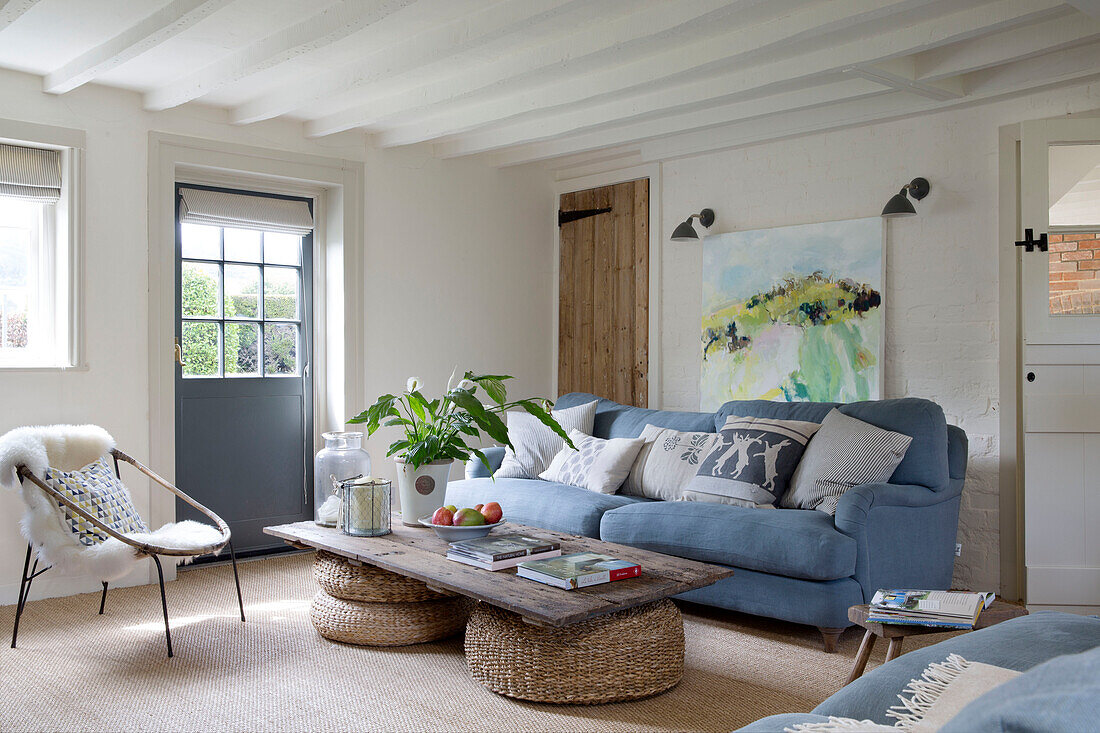 Light blue sofa with coffee table made out of old door in East Dean living room  West Sussex  UK