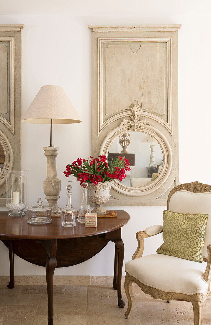 Circular mirror with drop leaf table and armchair in Var farmhouse Provence France