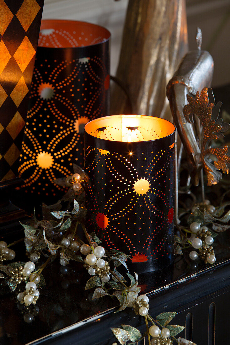 Lit decorative candles with vintage Christmas decorations in Sussex home England UK