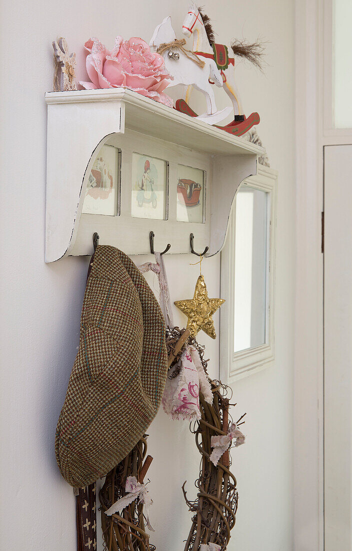 Flatcap and Christmas ornaments in London hallway England UK