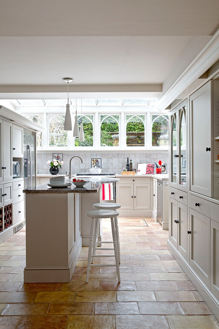 Marble breakfast bar in basement kitchen of Victorian terraced house London England UK