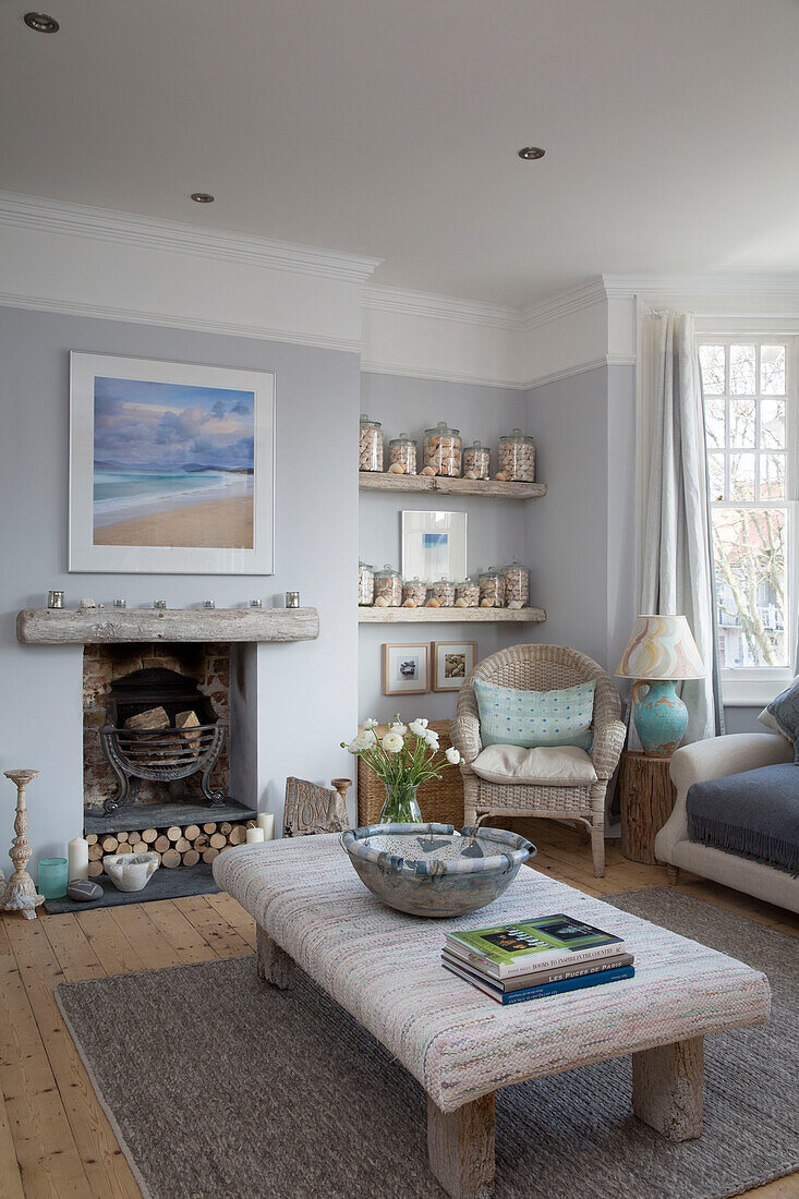 Ottoman covered in antique Swedish rag rug fabric in neutral blue living room of Sussex home England UK