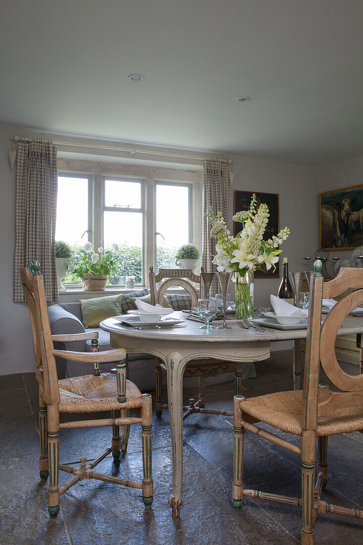 Cut flowers on dining table in Provencal style 18th century Dorset farmhouse England UK