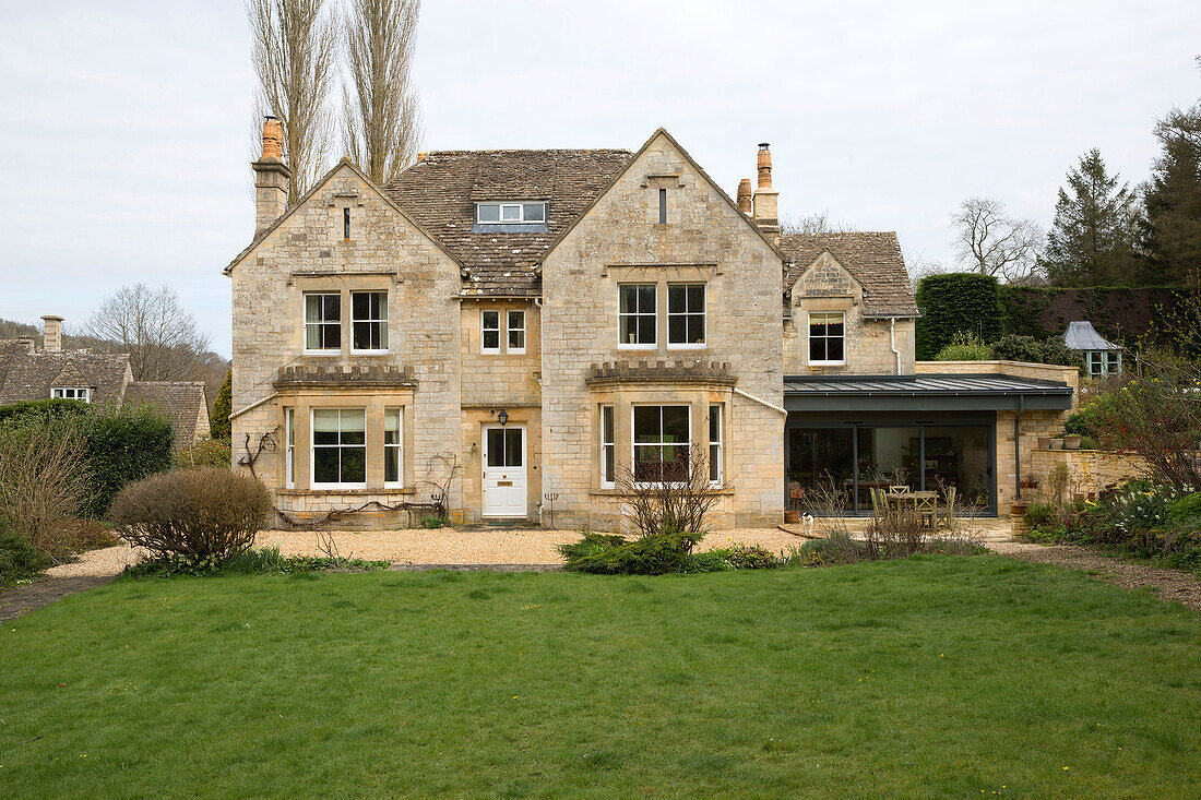 Stone exterior of detached Gloucestershire house England UK