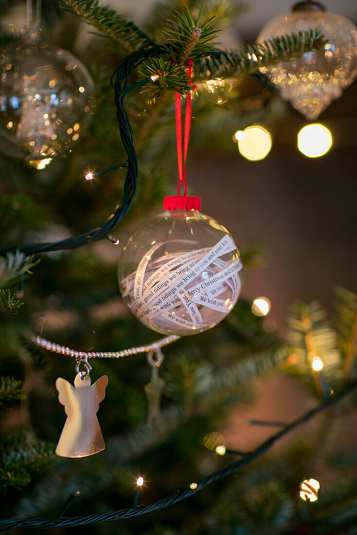 Bauble with carol lines on Christmas tree in Cheshire home UK