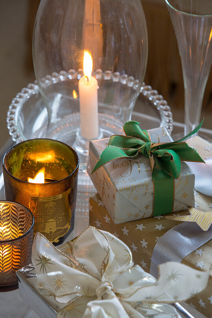 Lit tealights with Christmas gifts in London townhouse UK