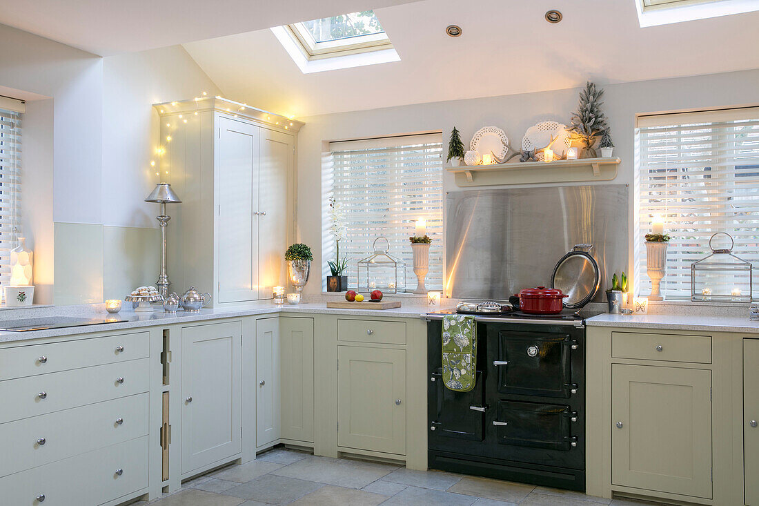 Black oven in light green fitted kitchen of 1890s Victorian villa Liverpool