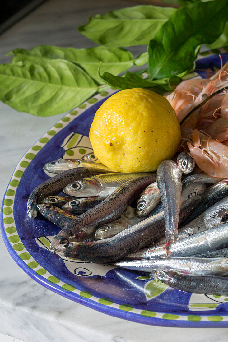 Sardines and shrimps with lemon on plate in Italian villa Amalfi Southwest Italy