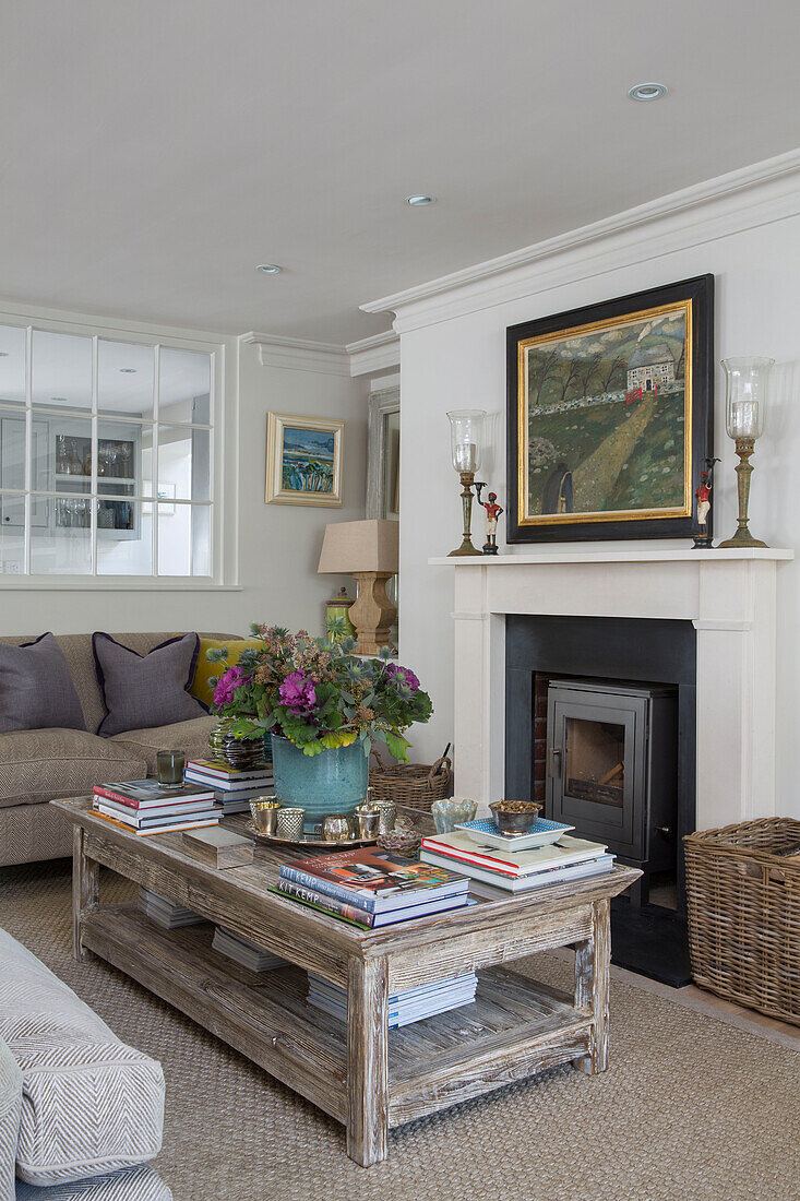 Houseplant and books on coffee table with woodburner in West Sussex home