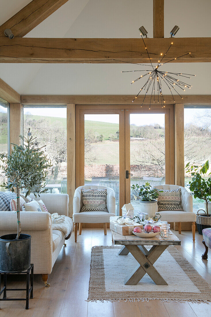 White sofa and chairs in windows of timber framed West Sussex farmhouse renovation UK