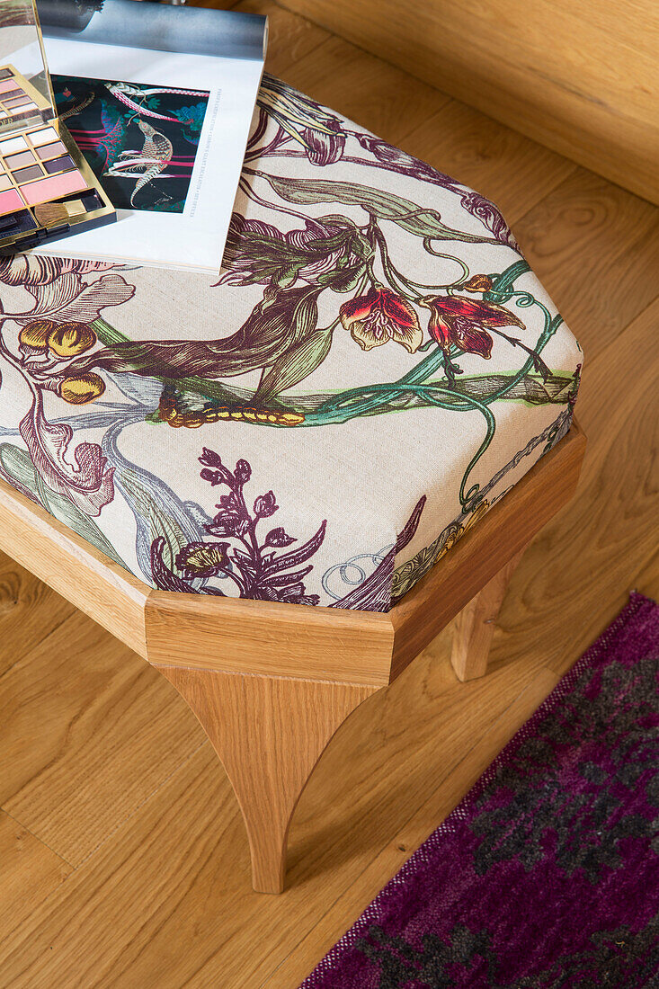 Eyeshadow and magazine on floral stool in Victorian London townhouse UK