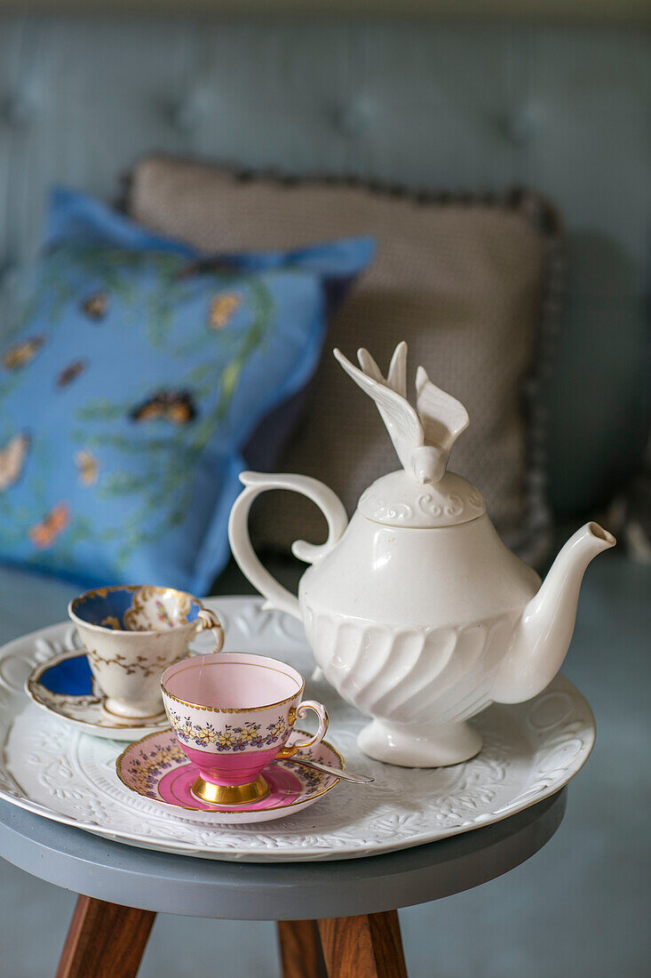 Teapot with cups and saucers on tray in detached Kent home UK