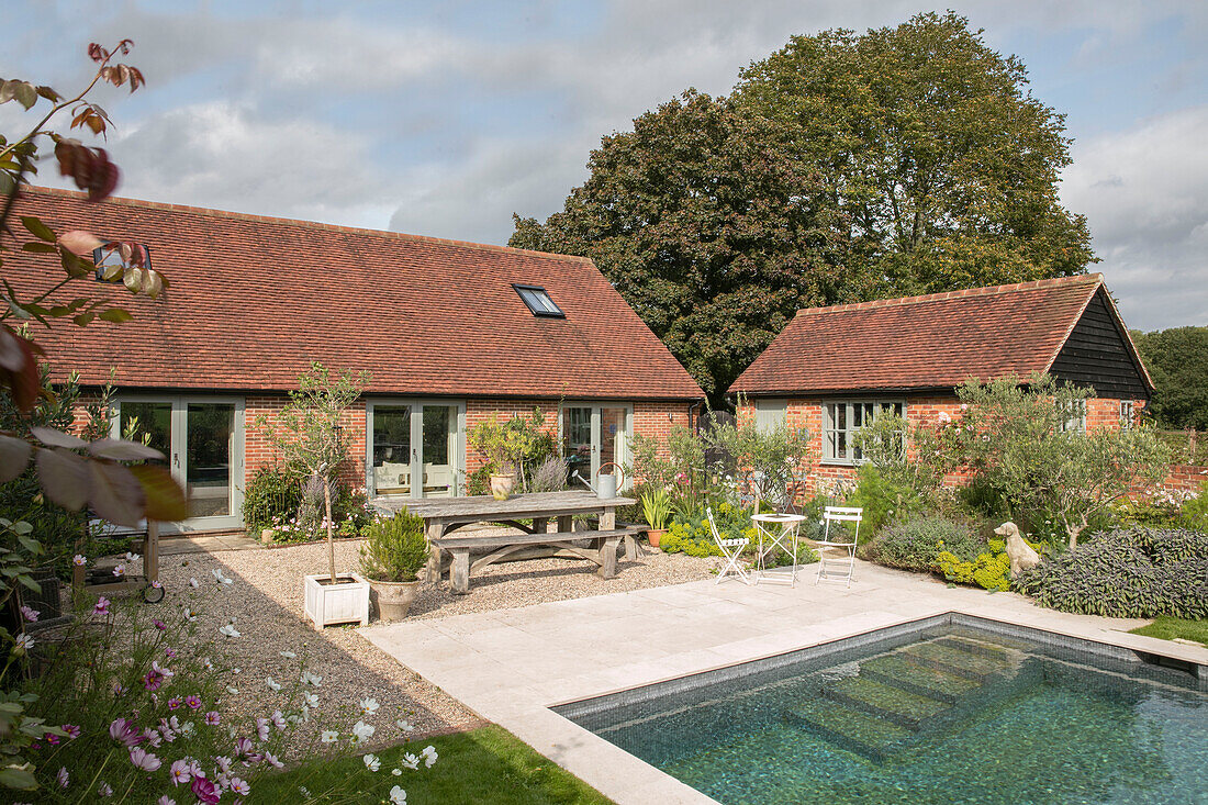 Picnic table at poolside in Oxfordshire garden UK