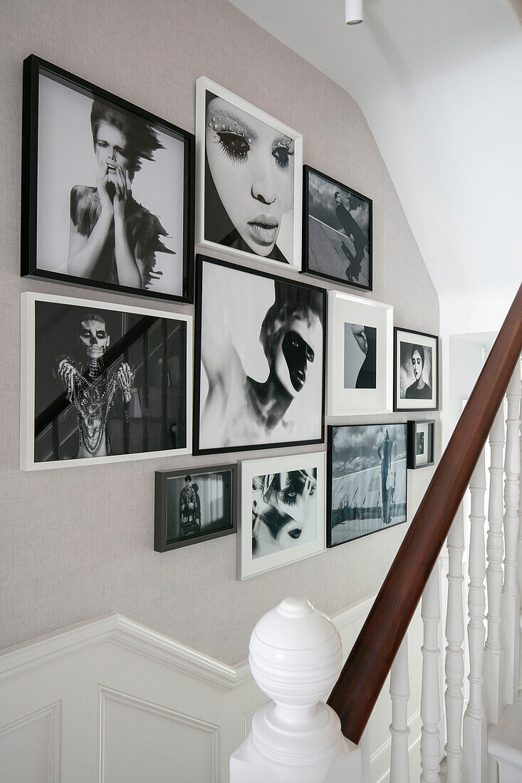 Framed black and white photographs in staircase of London home UK