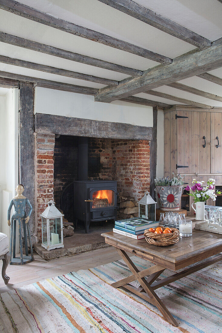 Stone fireplace c1600?s with French coffee table in Surrey farmhouse UK