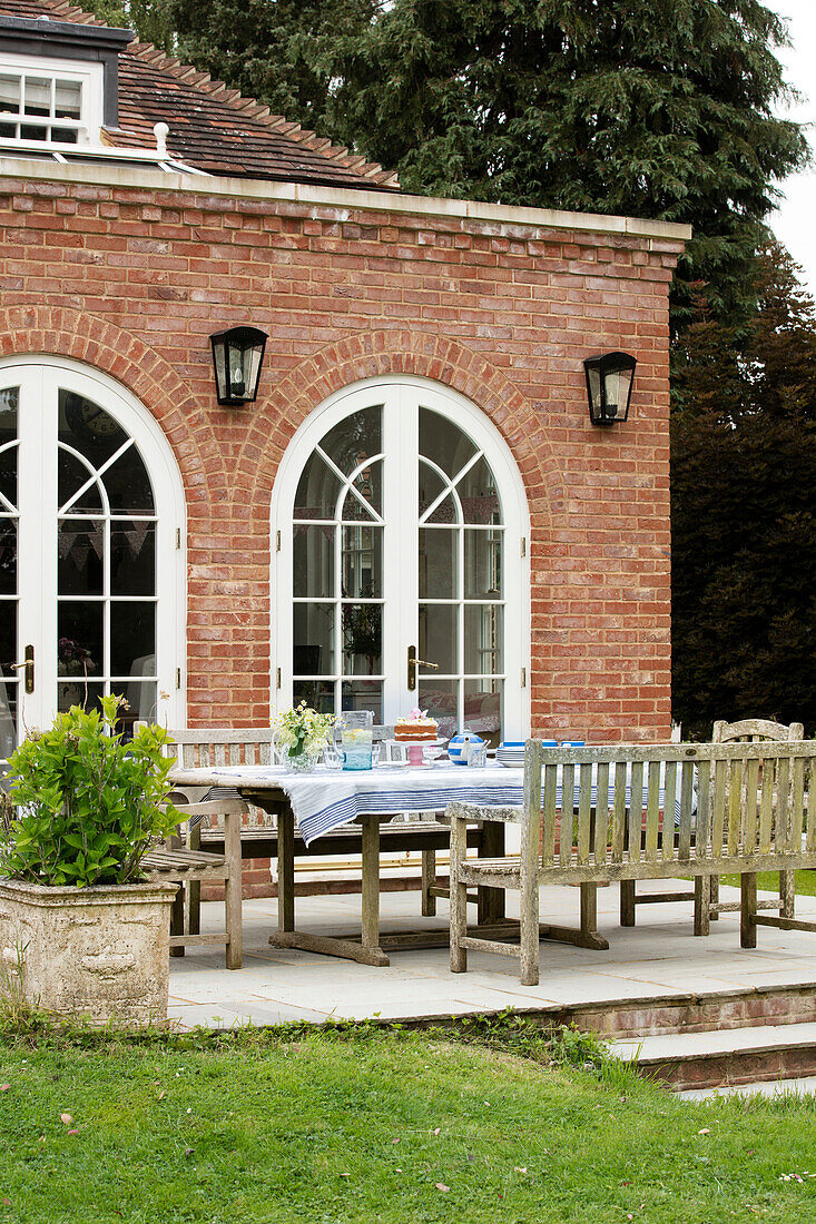 Patio furniture outside 1930s Georgian rectory extension West Sussex UK