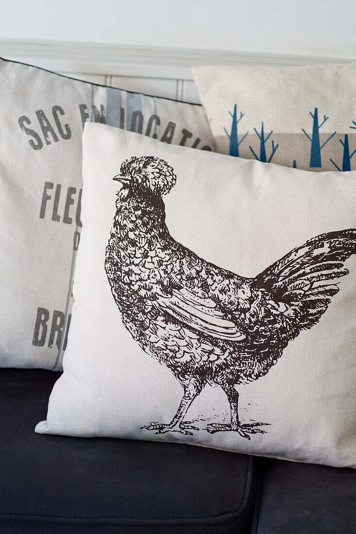 Hen cushion on bench seat in Wiltshire cottage UK