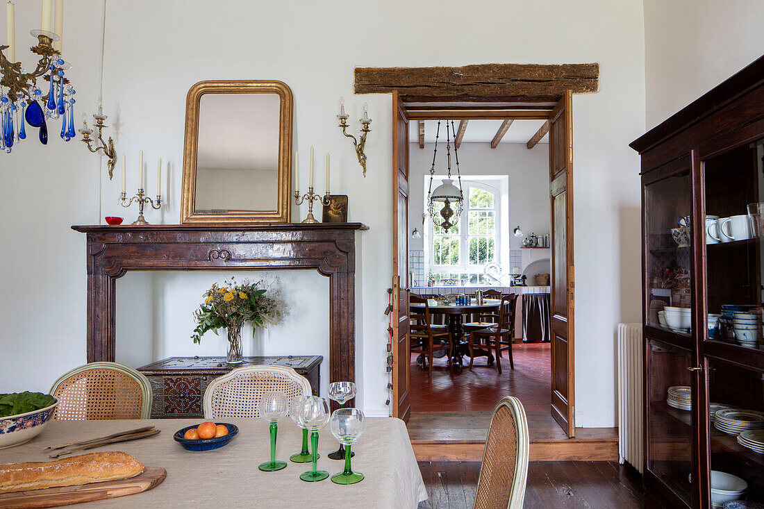 Fireplace with early 1900s French dining chairs and Italian Rococo art deco cabinet in French chateau Lot et Garonne