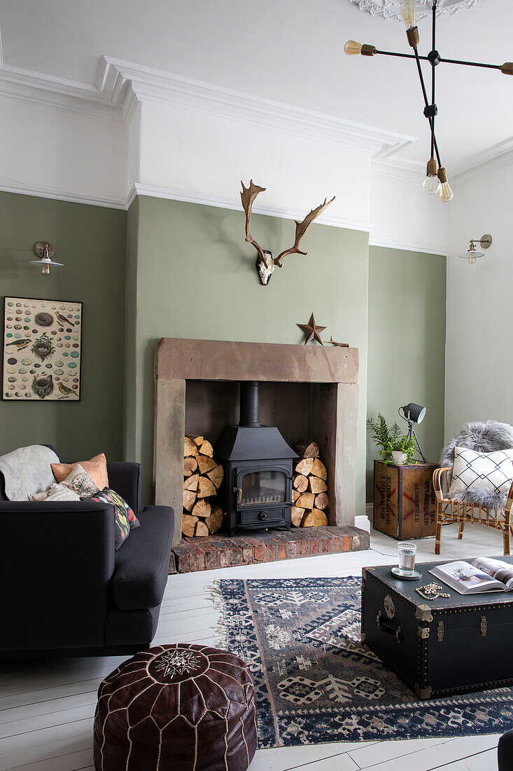 Wall in 'Lichen' with sheepskin antlers and fire surround made from old stone gate posts and Molecular Pendant in Cumbrian terrace UK