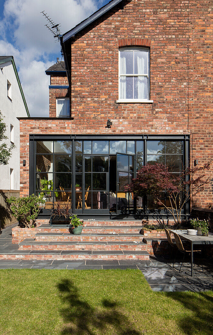 Brick extension with steel-framed windows Victorian semi-detached home Manchester UK