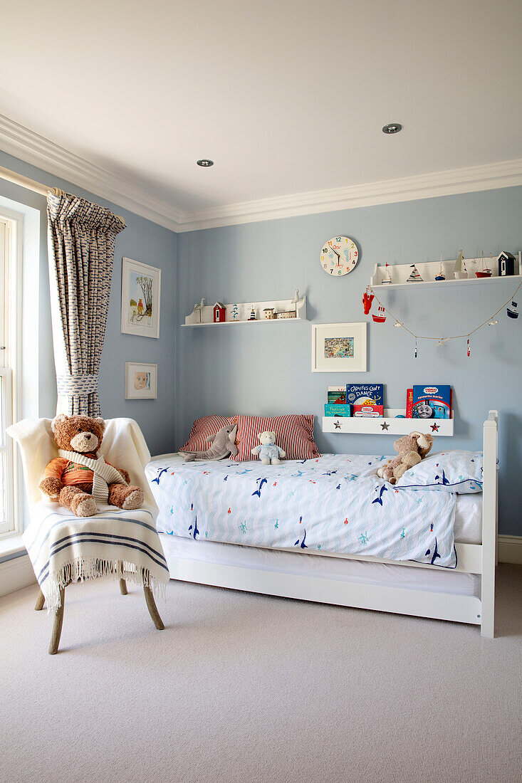 Teddybear on chair in nautical themed boys room Hampshire UK