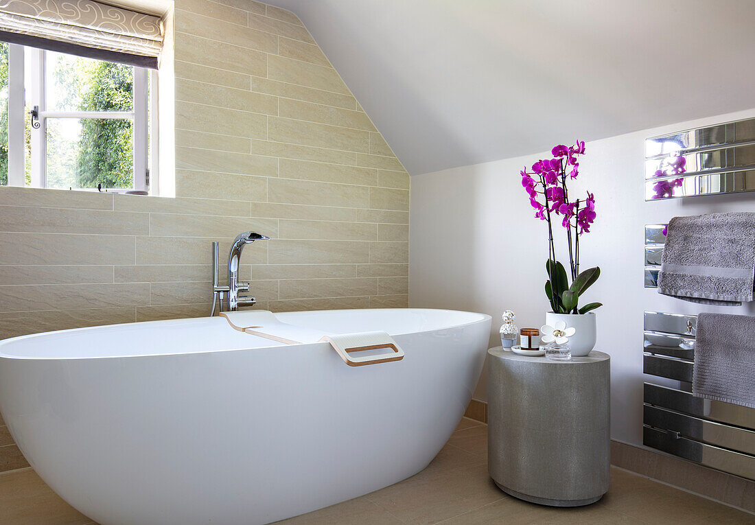 Freestanding bath and pink orchid Surrey UK