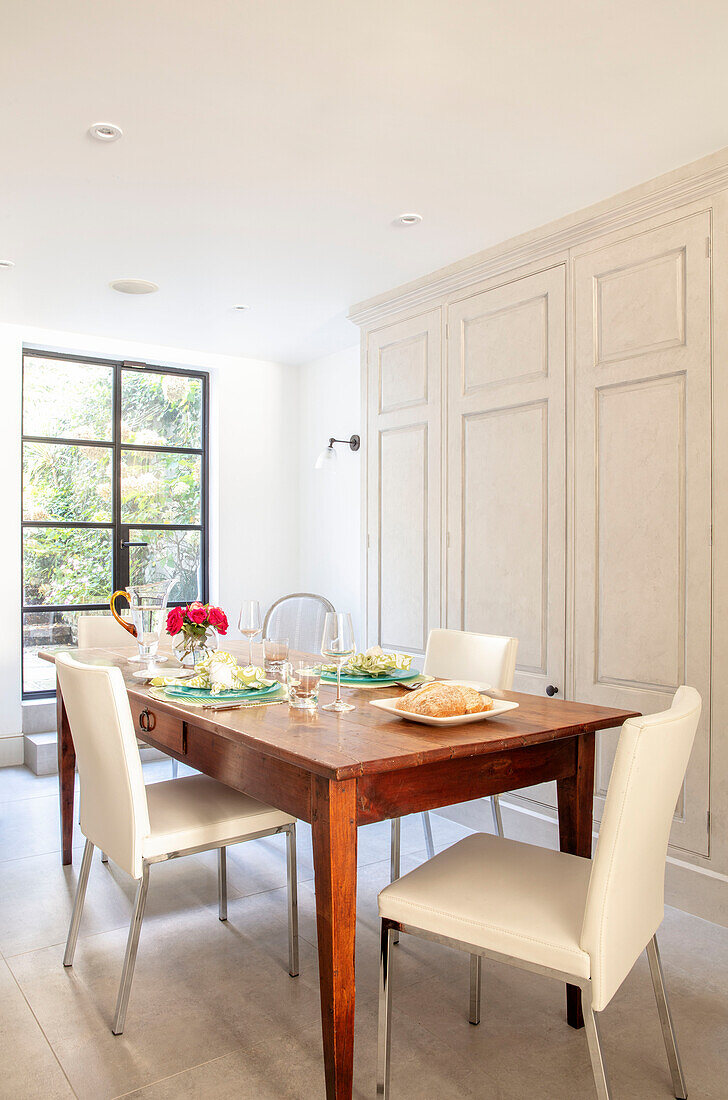 Bread and salad on wooden dining table London UK