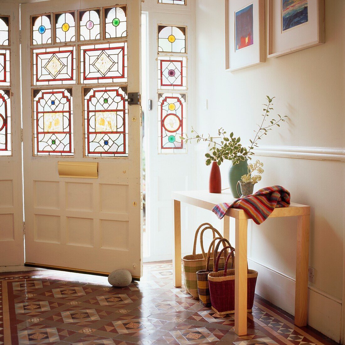 Entrance hall with tiled floor and stained glass door