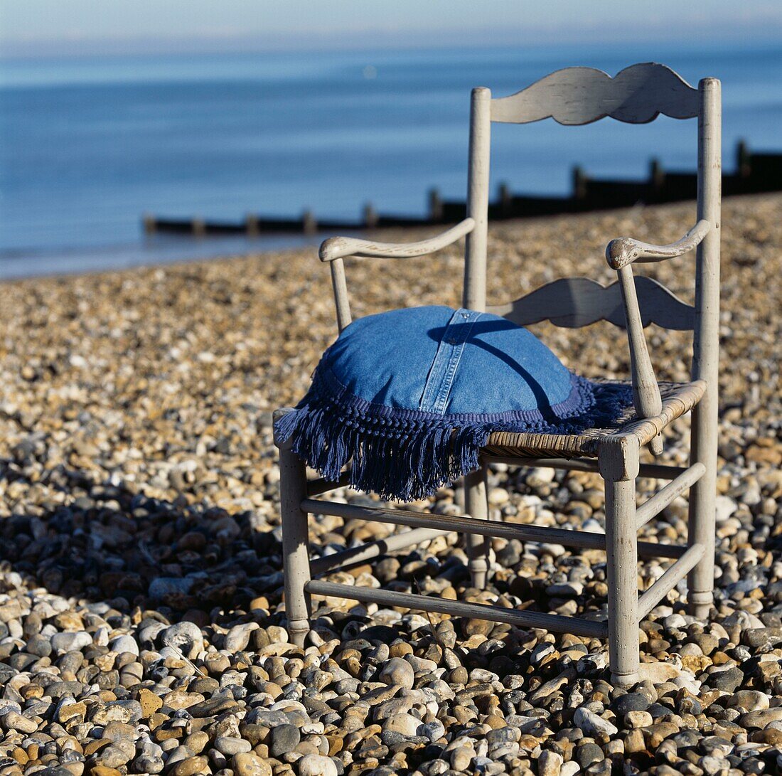 Vintage style chair with cushion on a single beach