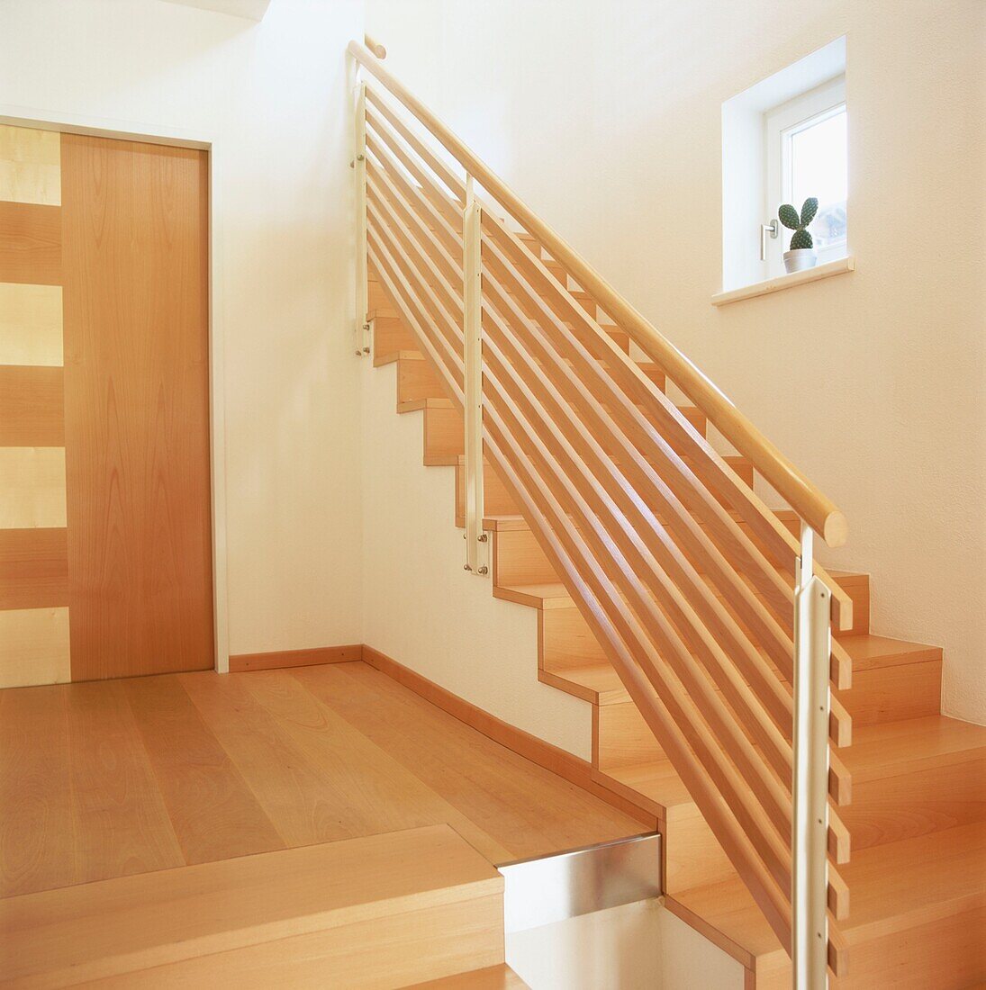 Contemporary entrance hall stairs and landing with wooden floors and steps