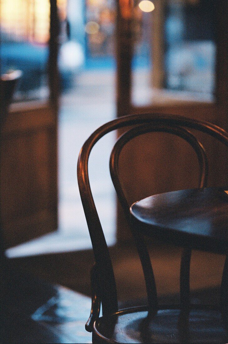 A bentwood chair next to wooden table in a bar