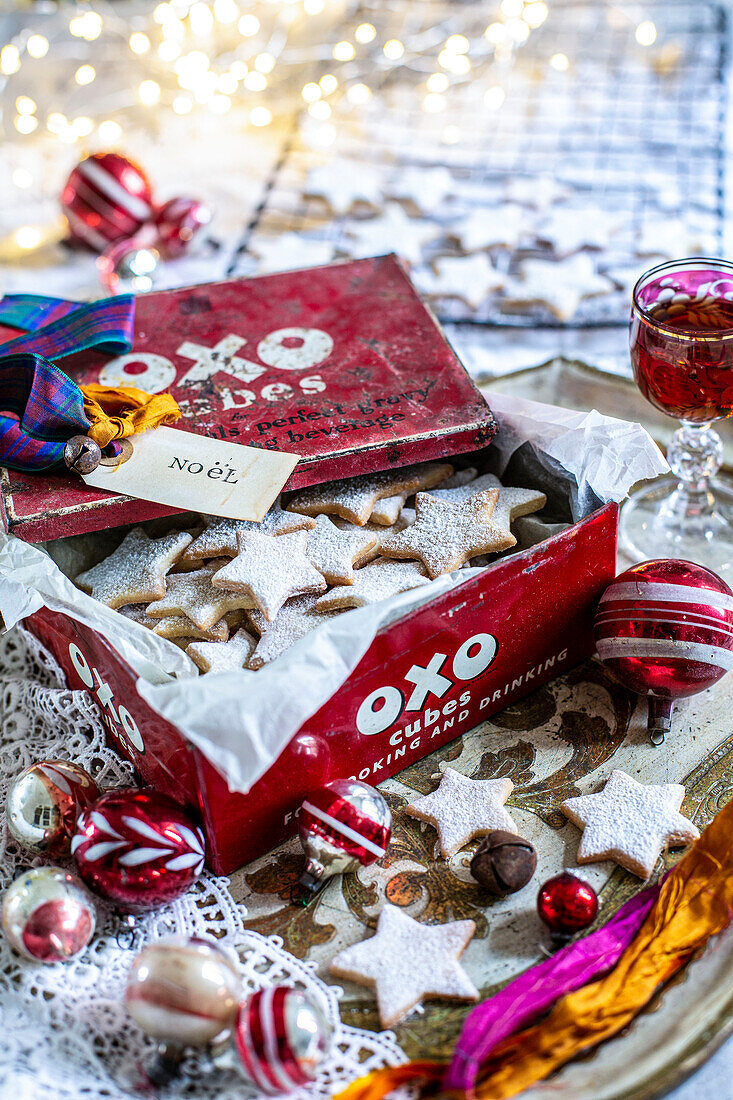 Home made festive star biscuits in vintage tin