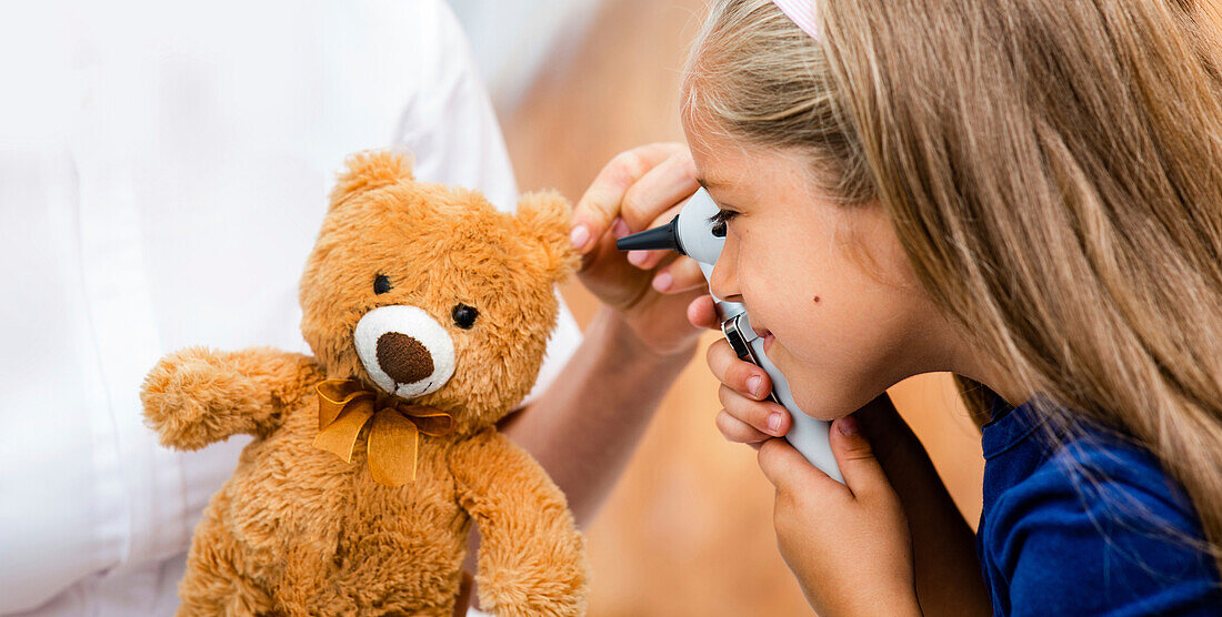 Girl playing with otoscope