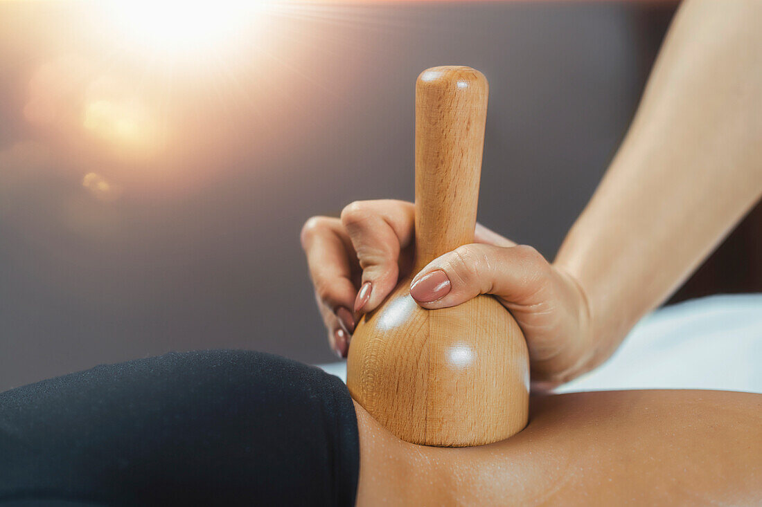 Anti-cellulite maderotherapy massage with wooden vacuum cup