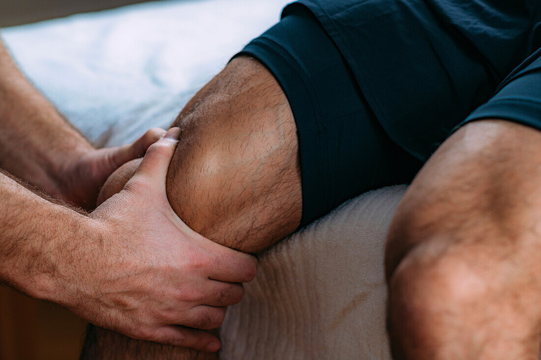 Physiotherapist massaging an injured knee