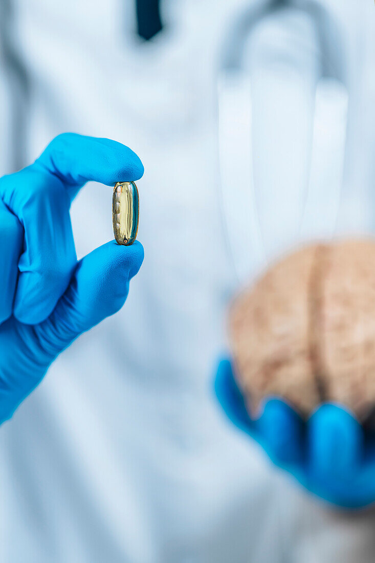 Female doctor holding model of brain and a placebo pill