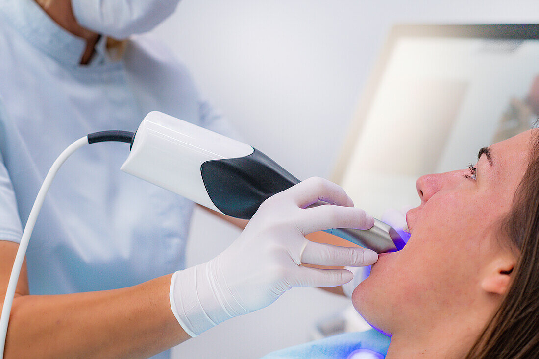 Dentist using 3D dental camera for scanning teeth