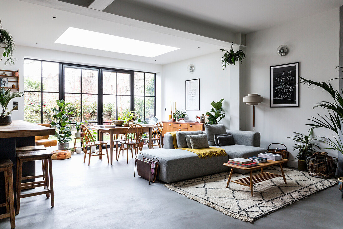 Open-plan living area with large window front, living room and dining room