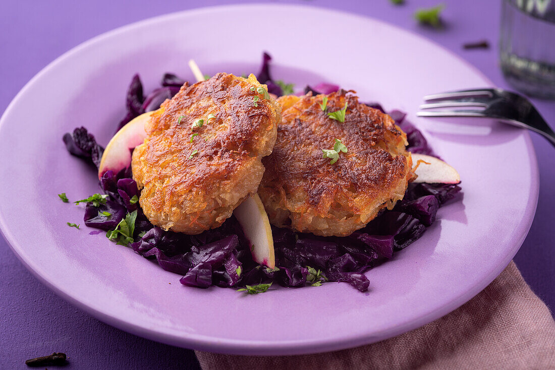 Vegan apple and red cabbage coleslaw with potato and carrot rösti