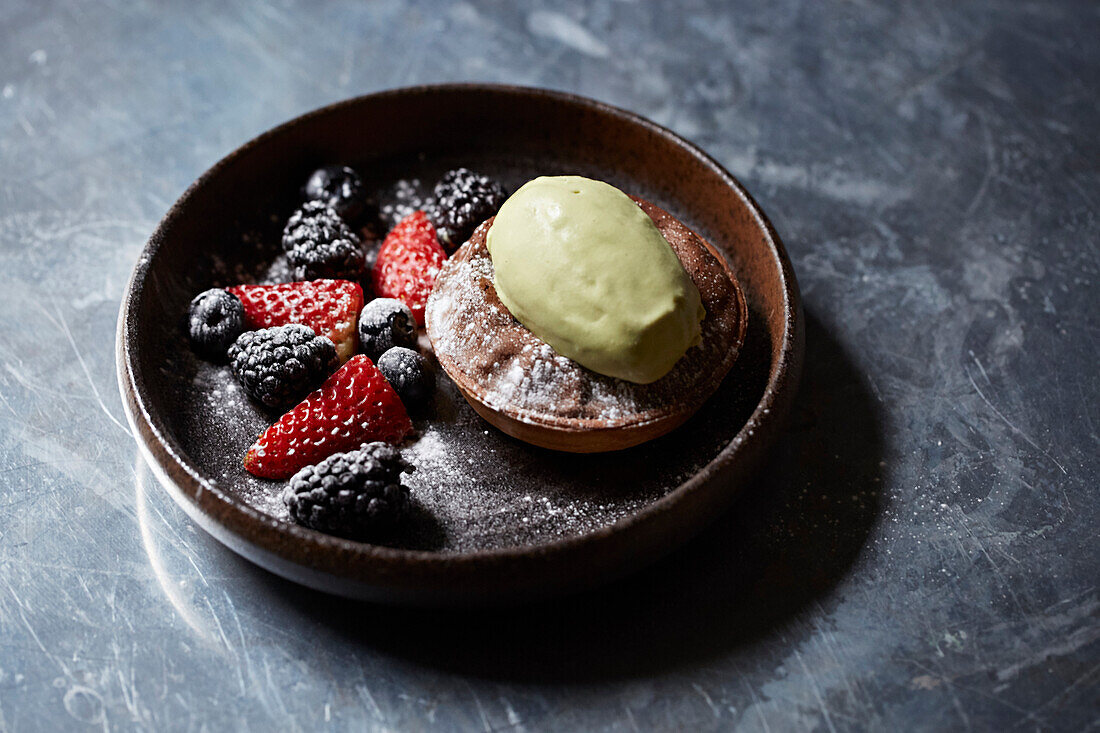 Chocolate torte with berries and a pistachio ice cream