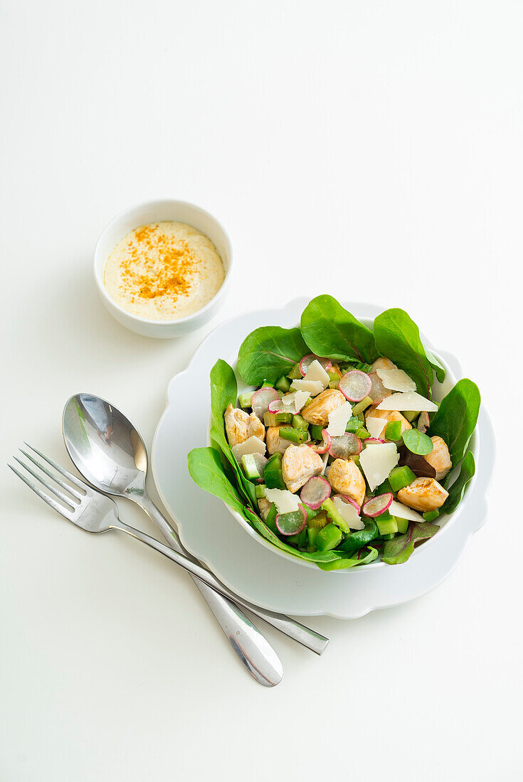 Salad with chicken breast, celery, radish and cucumber