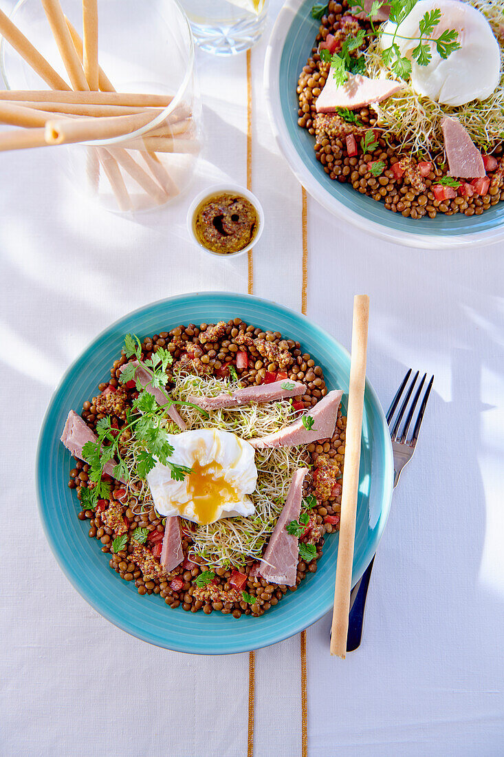 Lentil salad with poached egg, ham and sprouts