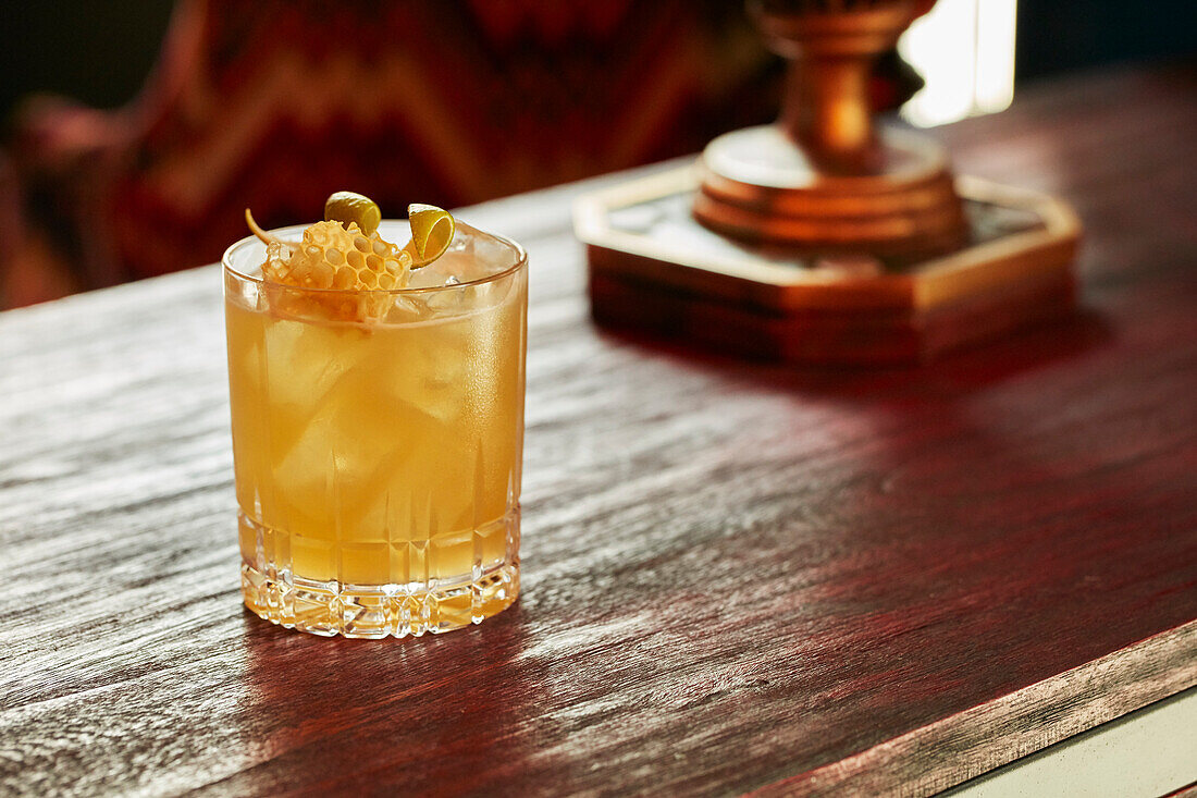 Whisky Cocktail garnished with honey comb