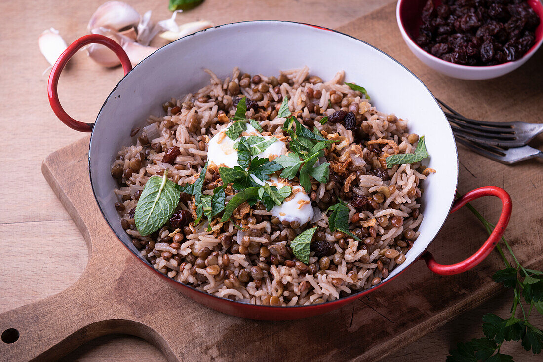 Lentil and rice pan with mint, sultanas, fried onions and soy yoghurt