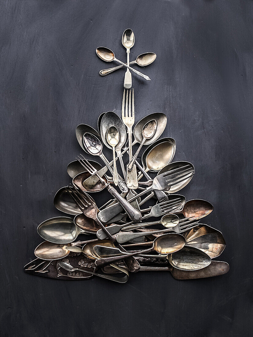 Vintage cutlery laid in the shape of a Christmas tree