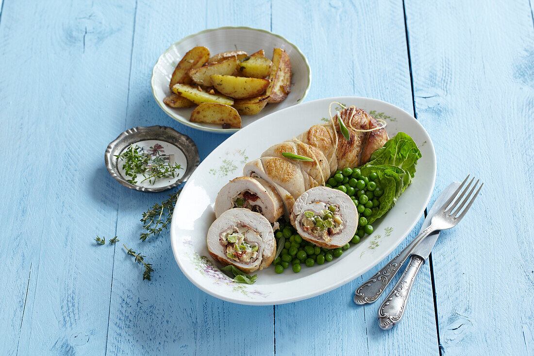 Turkey roll with peas and baked potatoes