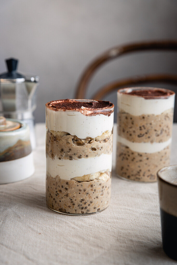 Overnight Oats with chia seeds, coffee, cream yoghurt and banana layered in a glass