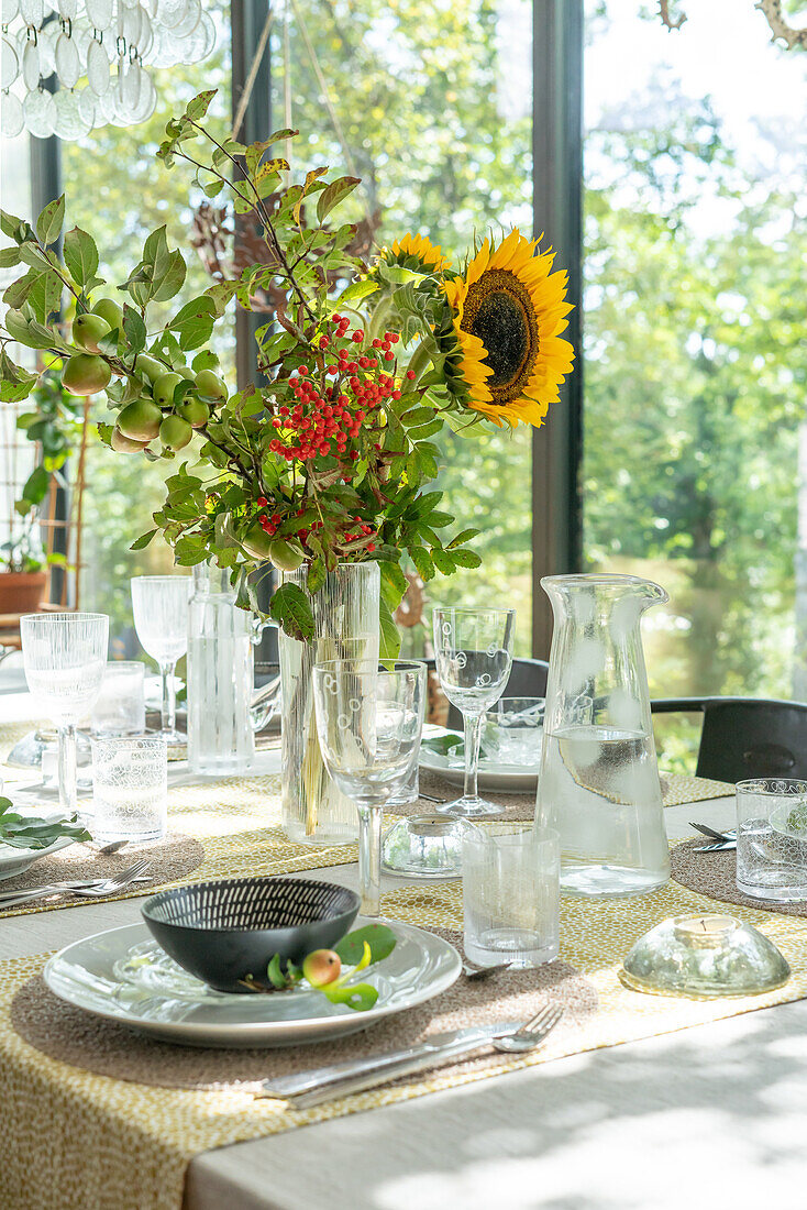 Set table with bouquet of sunflowers in front of window front