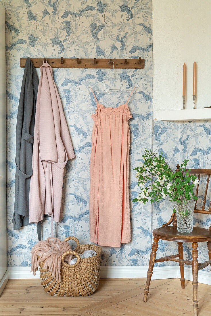 Wall with blue pattern, wooden wardrobe and woven basket