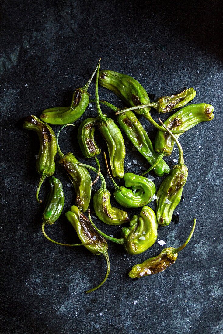 Blistered Shishito Peppers on Dark Background